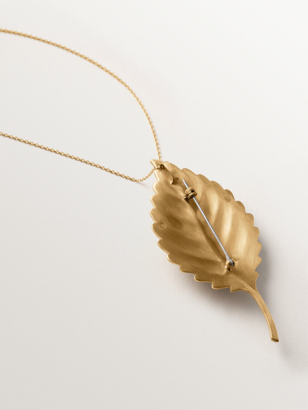 Yellow gold plated brooch-charm with crystals and leaf and insect shape