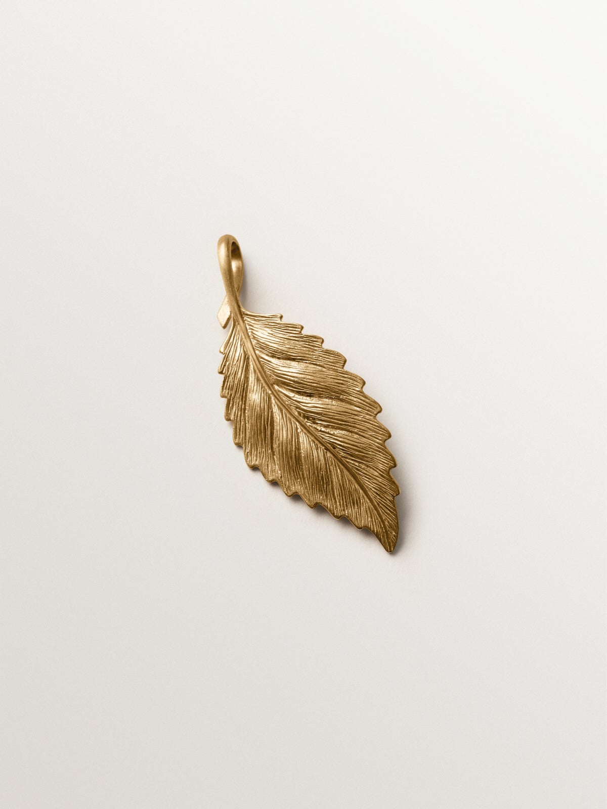 Yellow gold plated charm in leaf shape