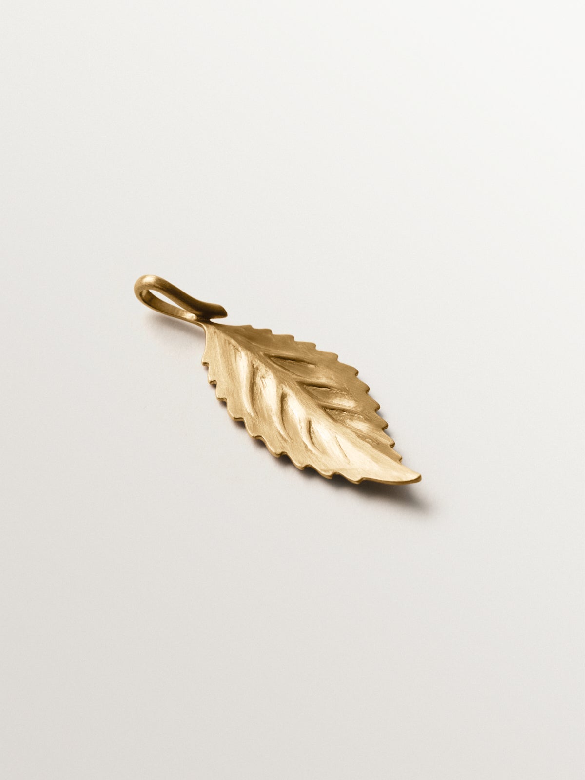 Yellow gold plated charm in leaf shape
