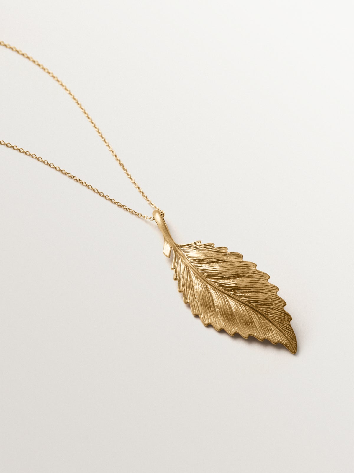 Yellow gold plated charm in leaf shape