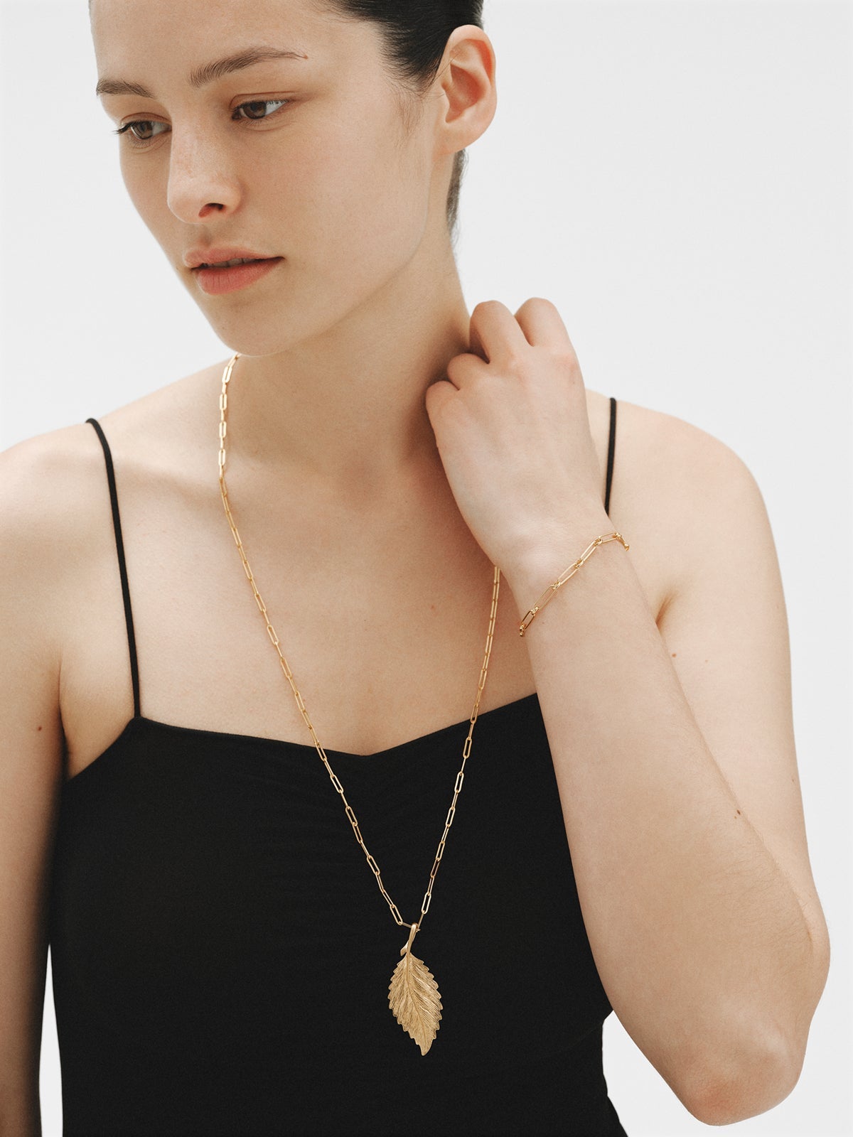 Yellow gold plated charm in leaf shape