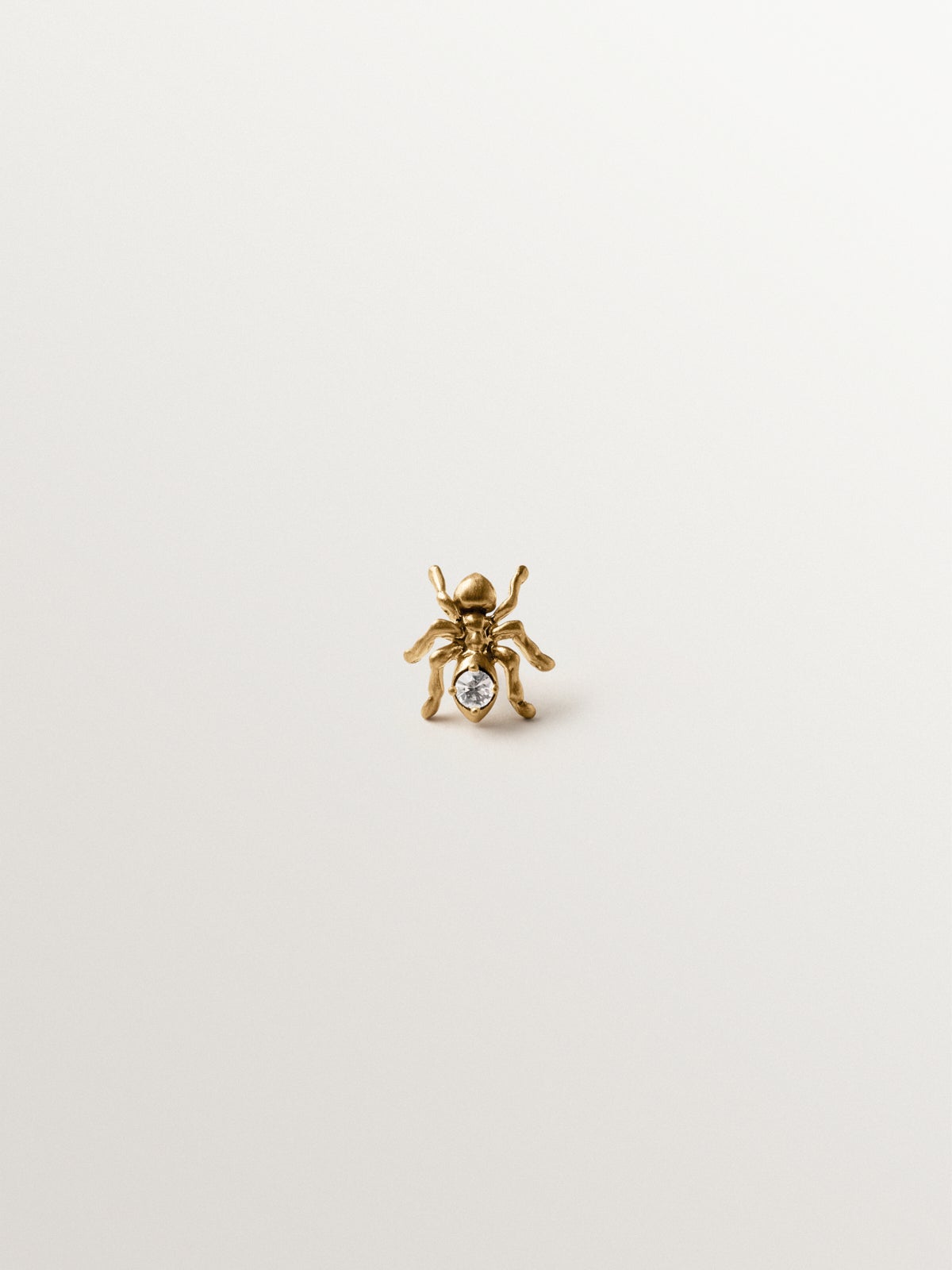 Yellow gold plated pin with crystal and ant shape