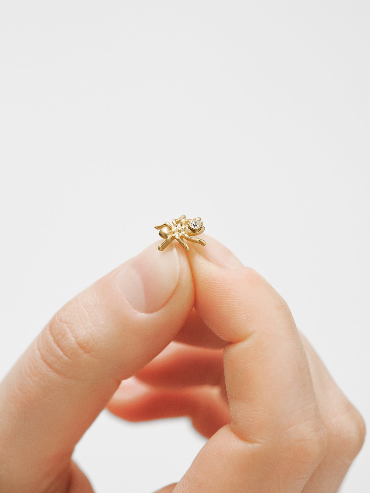 Yellow gold plated pin with crystal and ant shape