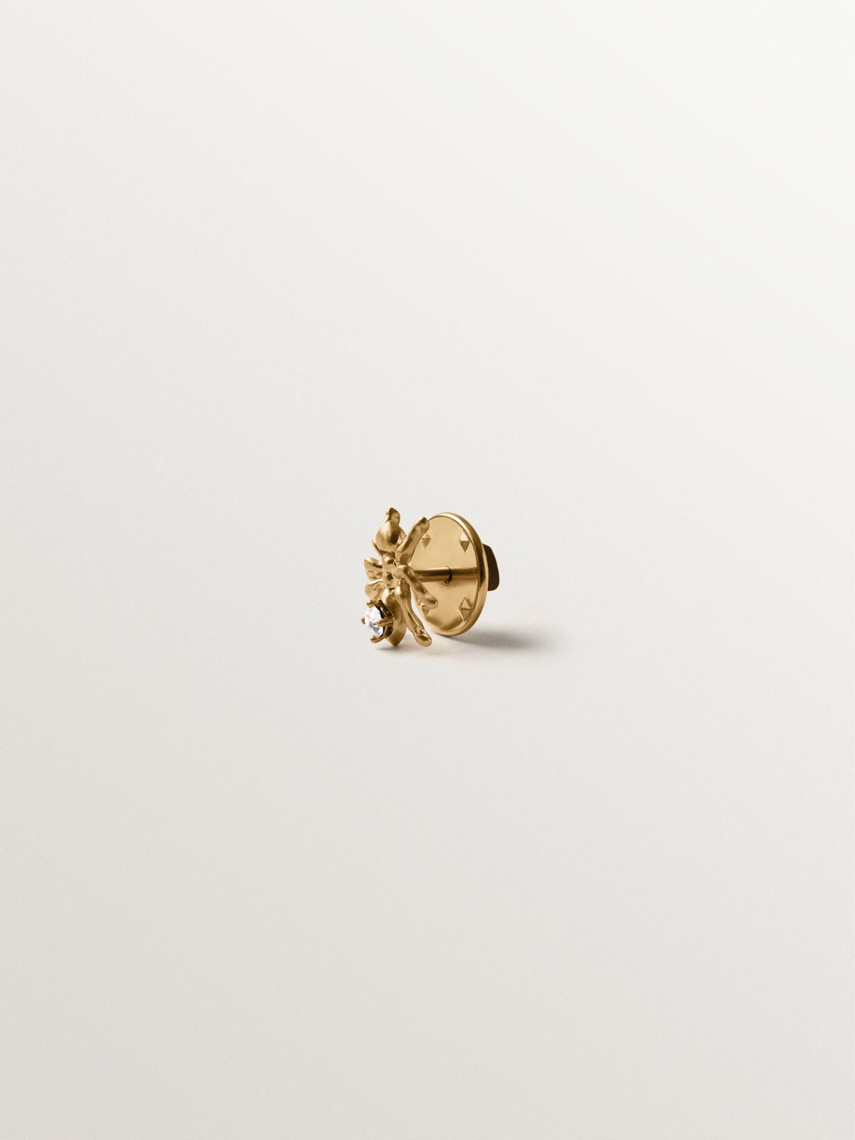 Yellow gold plated pin with crystal and ant shape