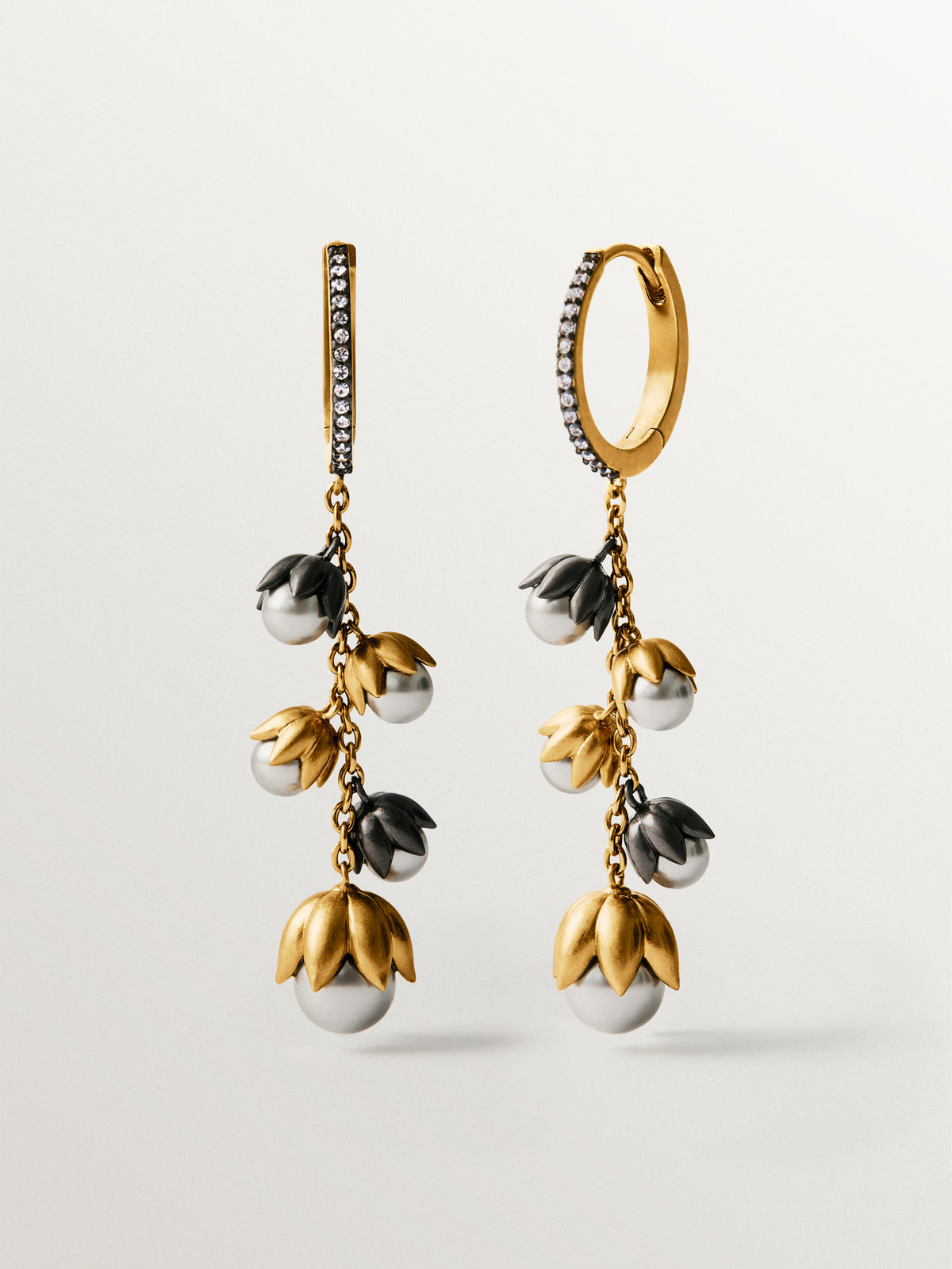 Two-tone yellow gold-plated earrings with gunmetal finish, white crystals and flower-shaped grey crystals