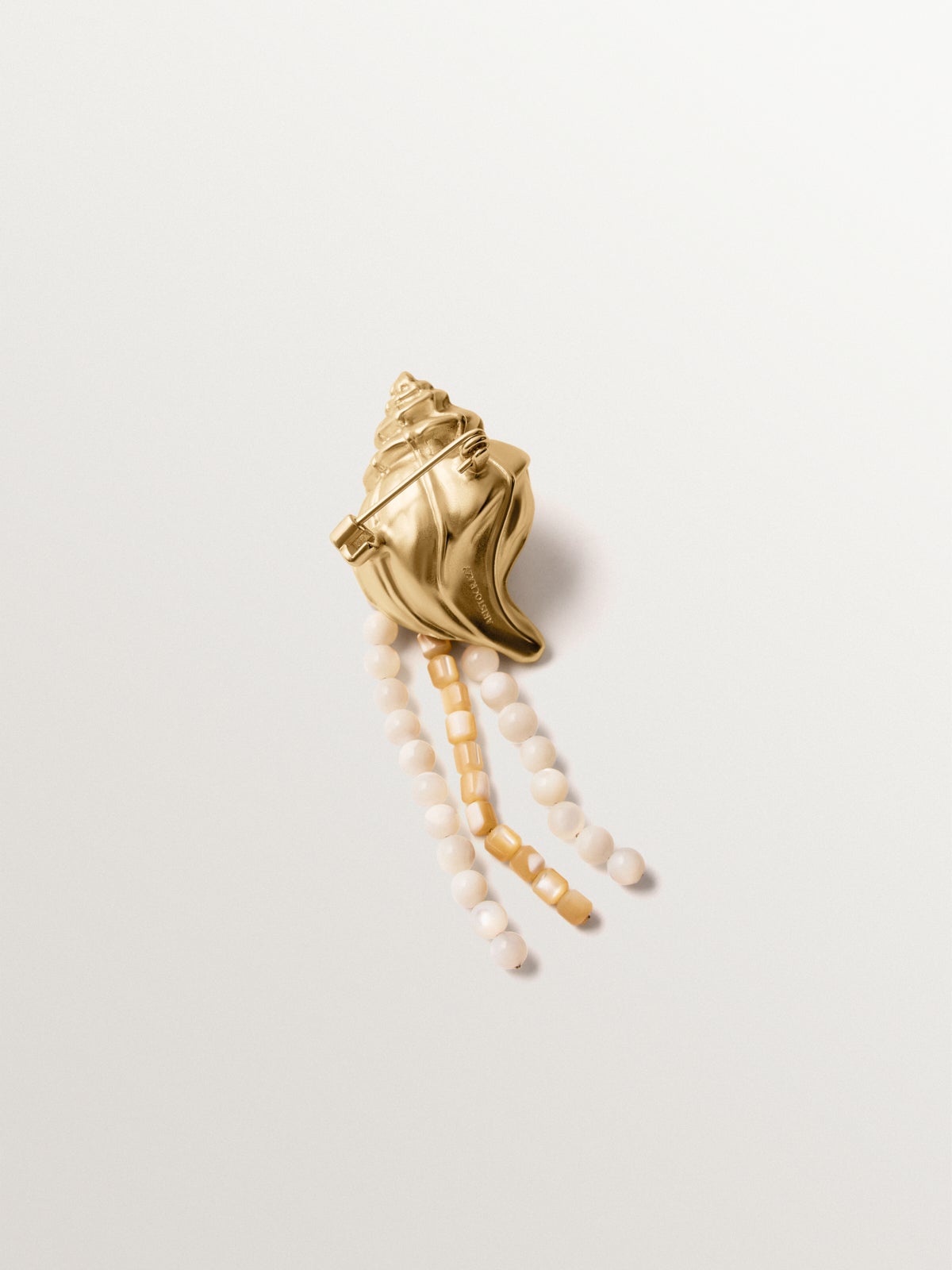 Yellow gold plated brooch with crystals, white balls and shell shape