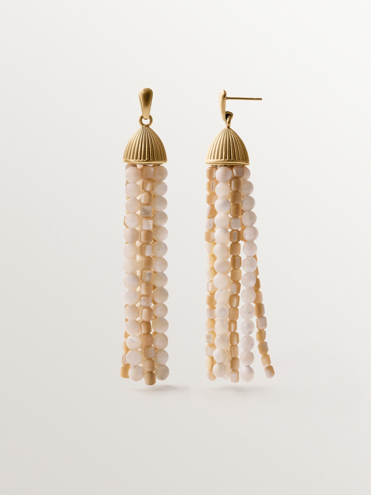 Cascading earrings plated in yellow gold with white beads