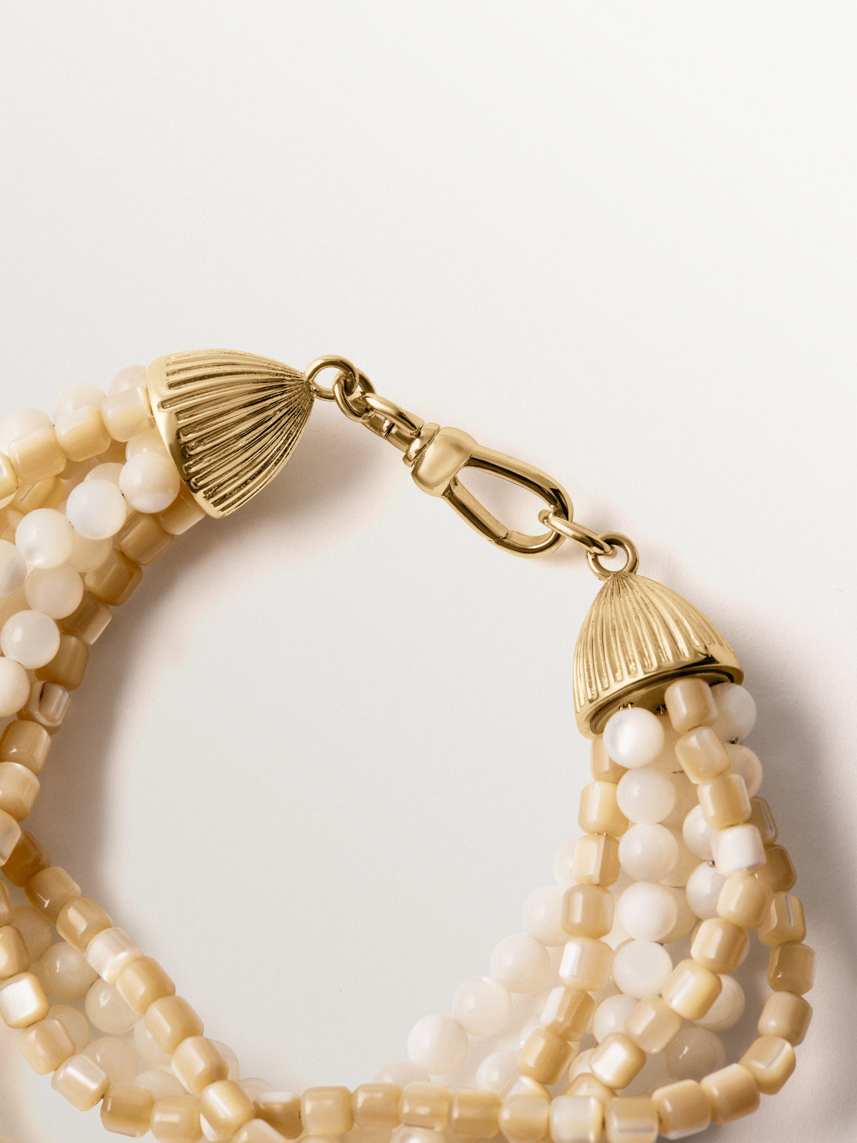 Yellow gold-plated bracelet with mother-of-pearl beads