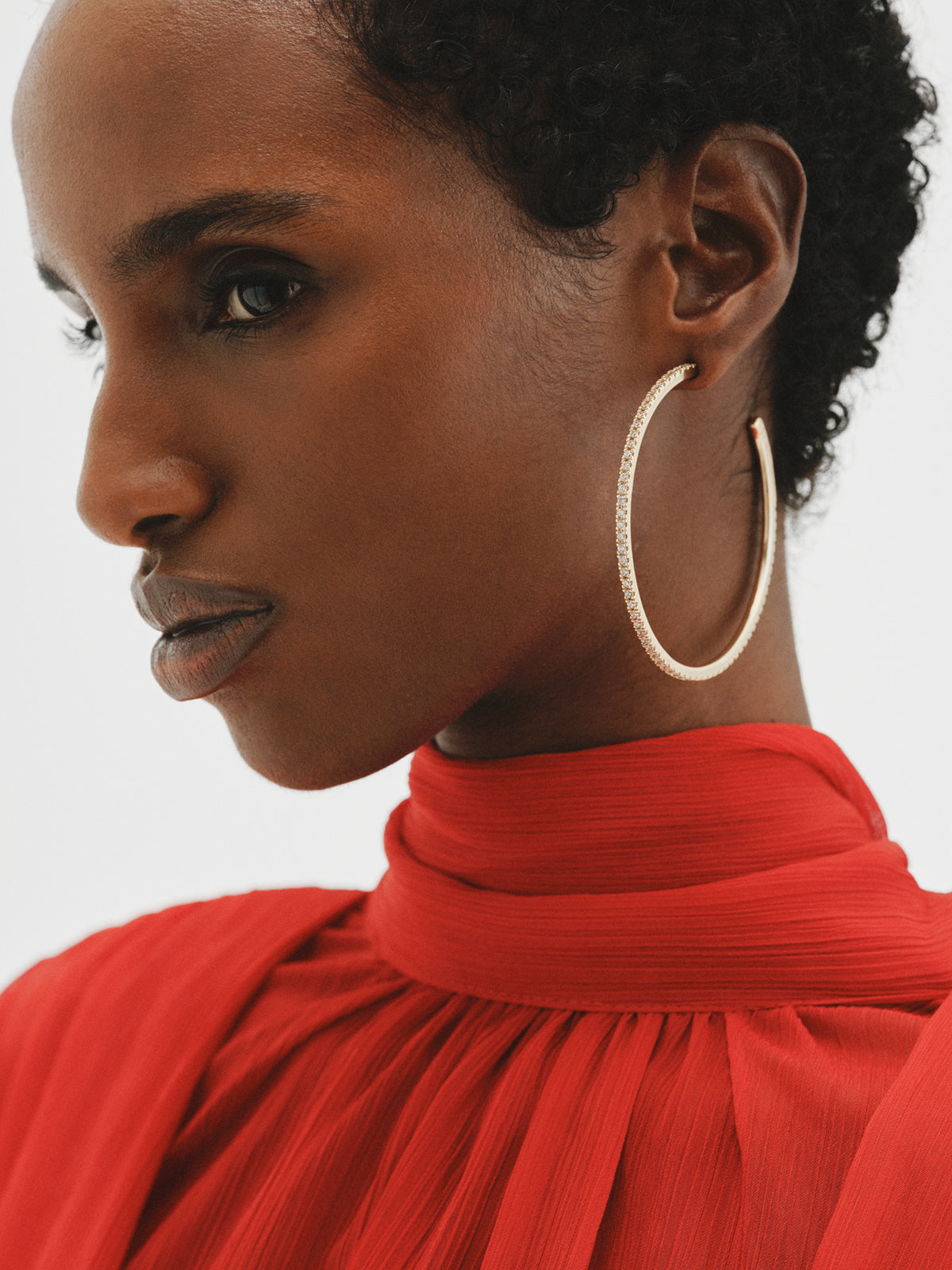 Large yellow gold-plated hoop earrings with crystals