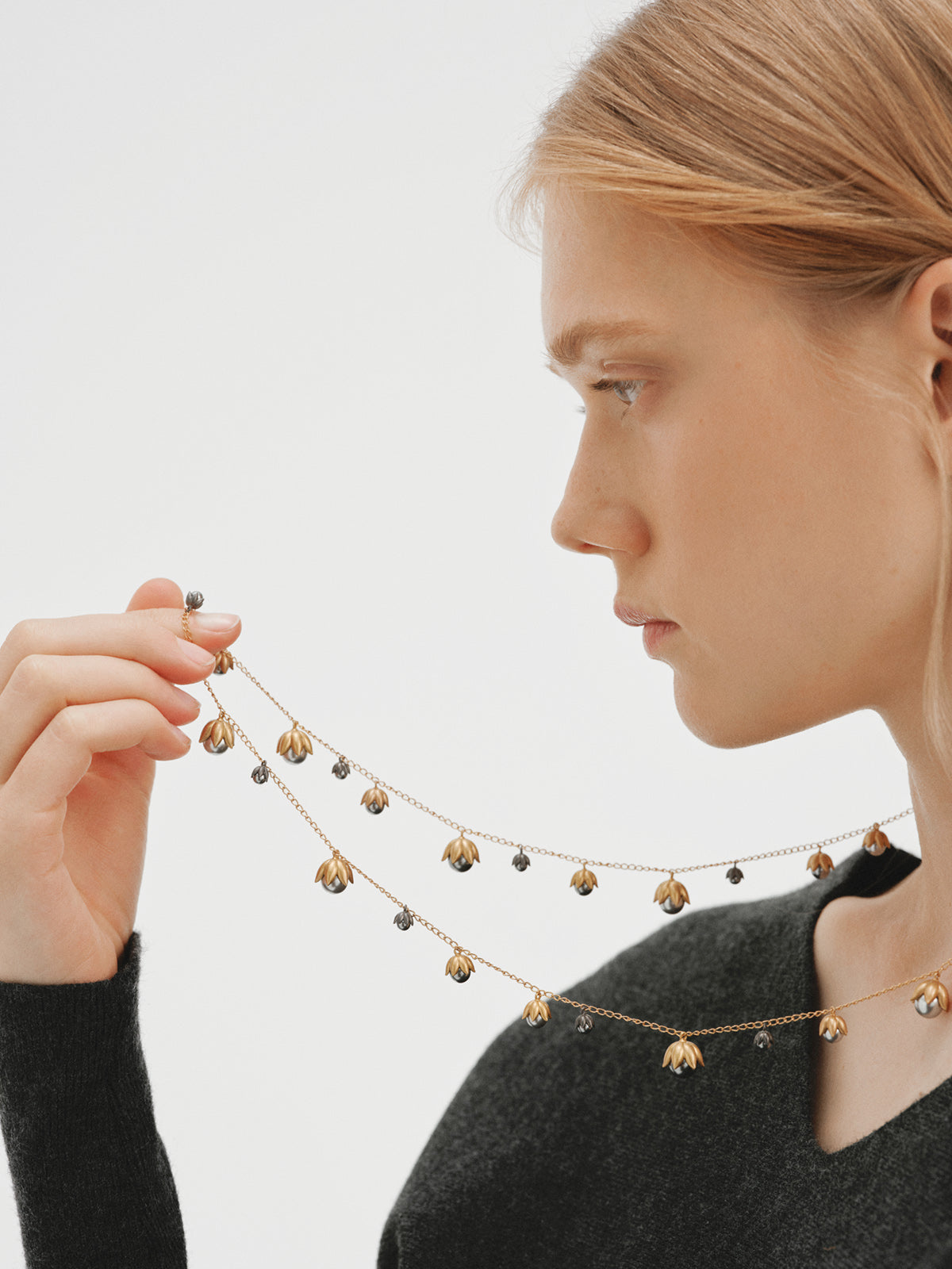 Two-tone yellow gold-plated pendant with gunmetal finish and flower-shaped grey crystals