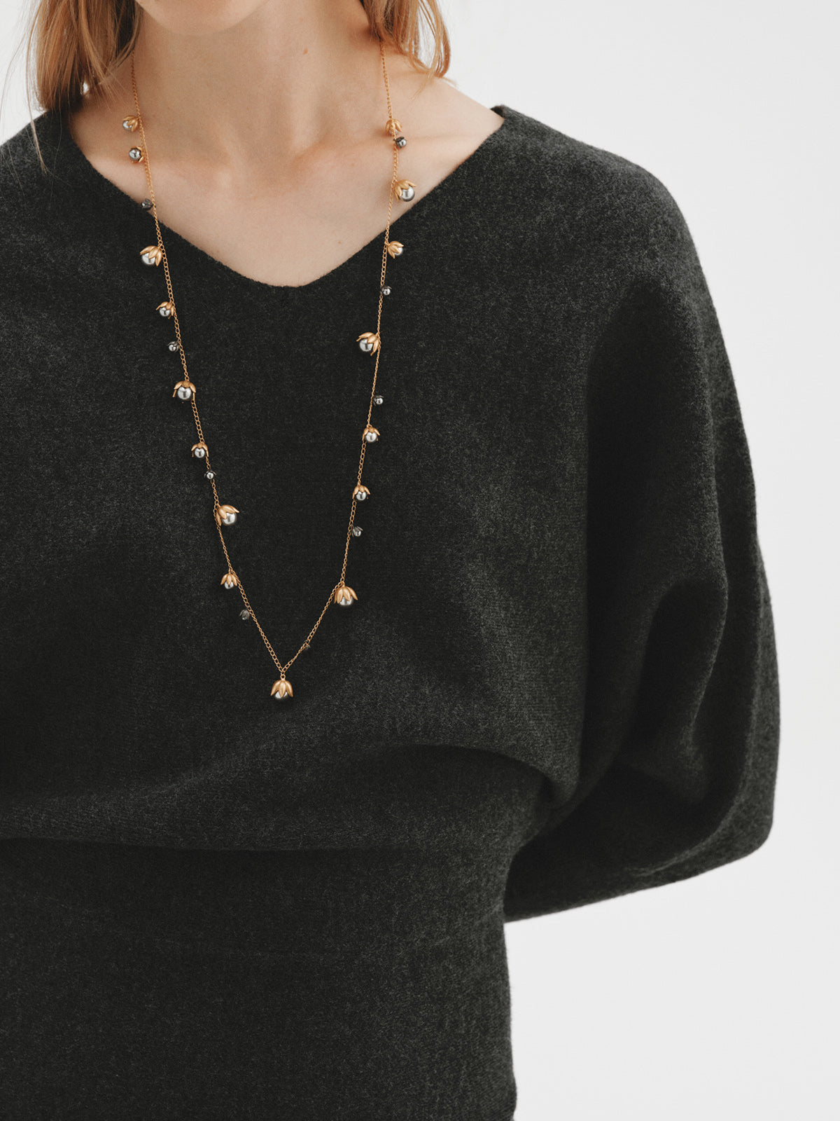 Two-tone yellow gold-plated pendant with gunmetal finish and flower-shaped grey crystals