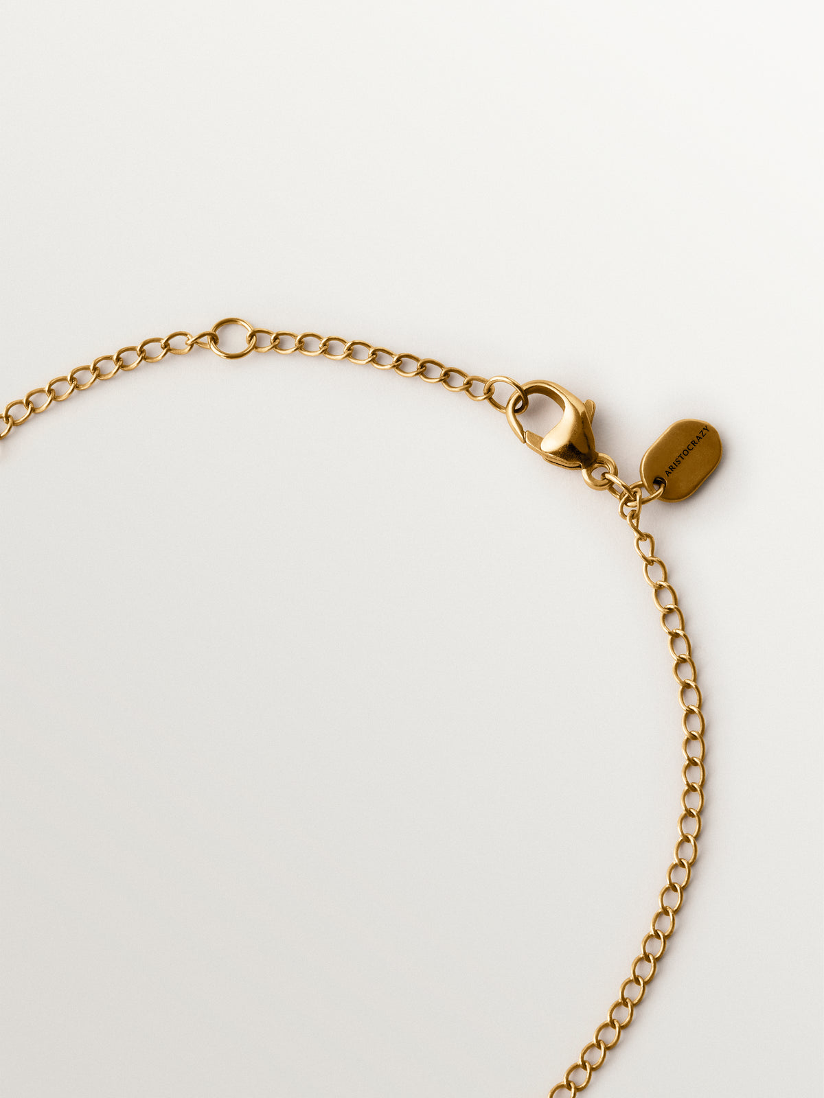 Two-tone yellow gold-plated pendant with gunmetal finish and flower-shaped grey crystals