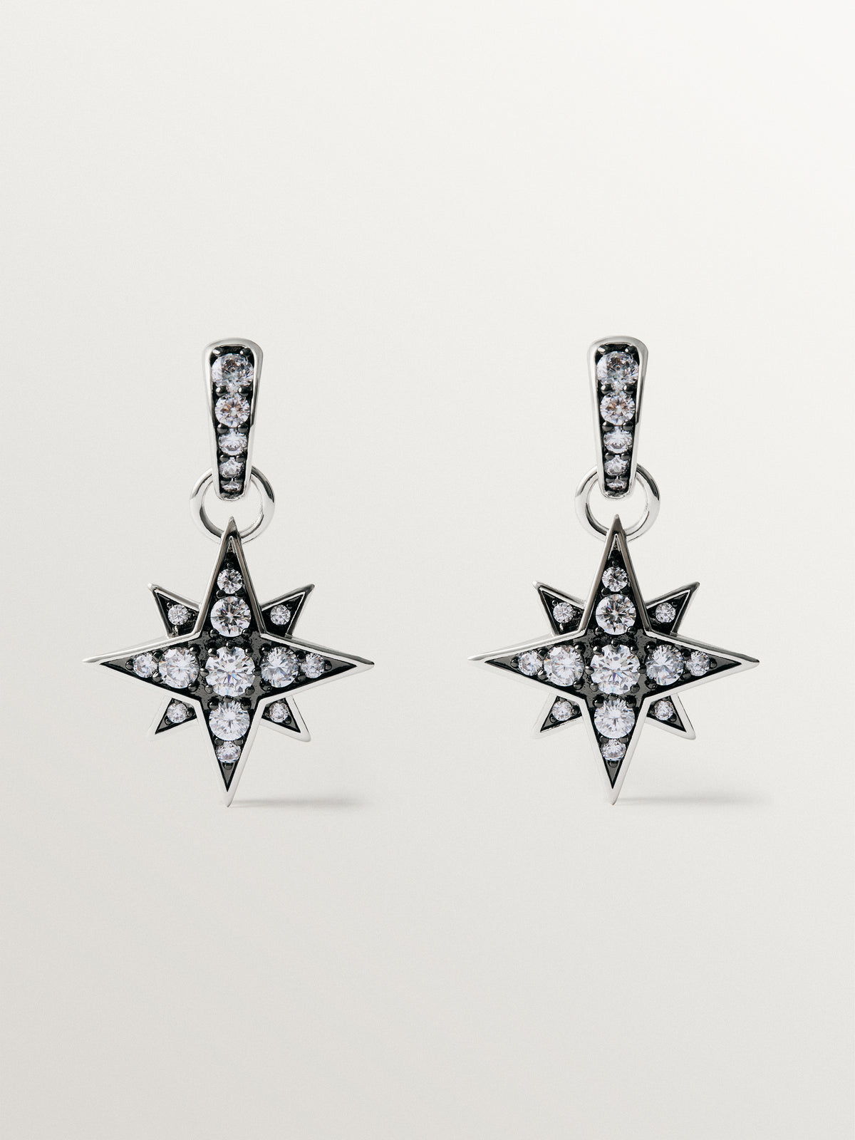 Two-tone hoop earrings with a large star-shaped crystal