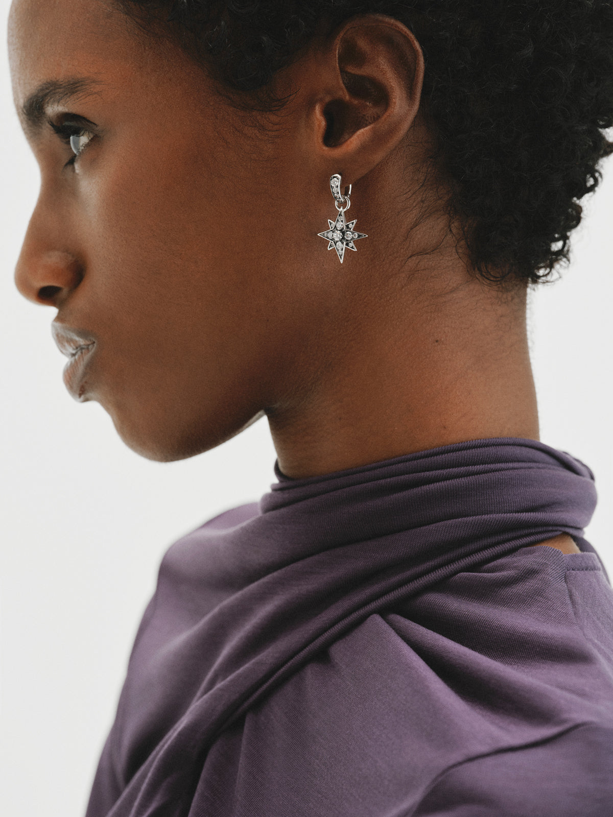 Two-tone hoop earrings with a large star-shaped crystal