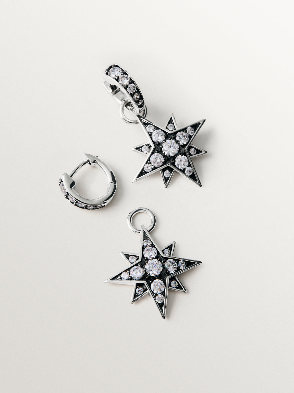 Two-tone hoop earrings with a large star-shaped crystal