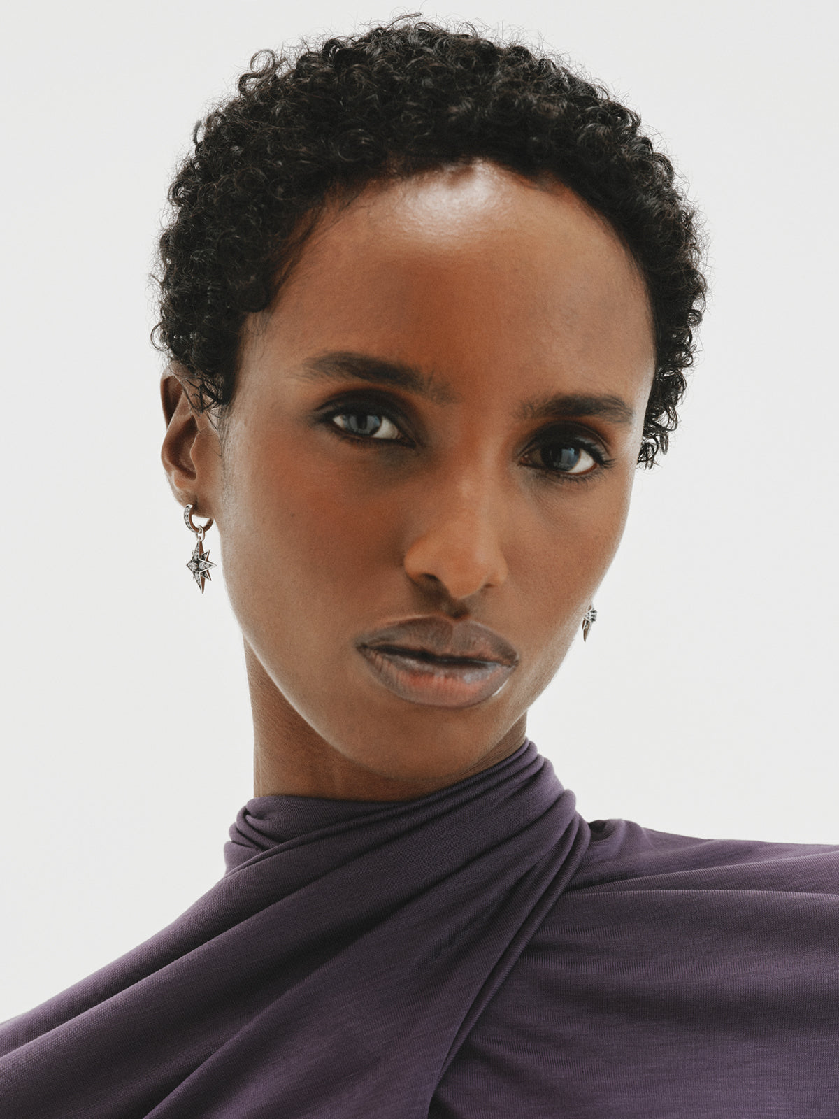 Two-tone hoop earrings with a large star-shaped crystal