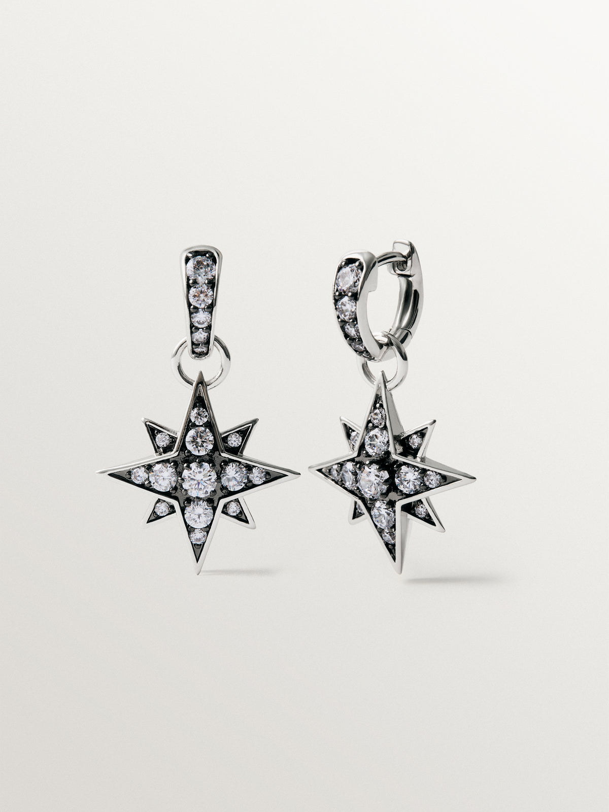 Two-tone hoop earrings with a large star-shaped crystal