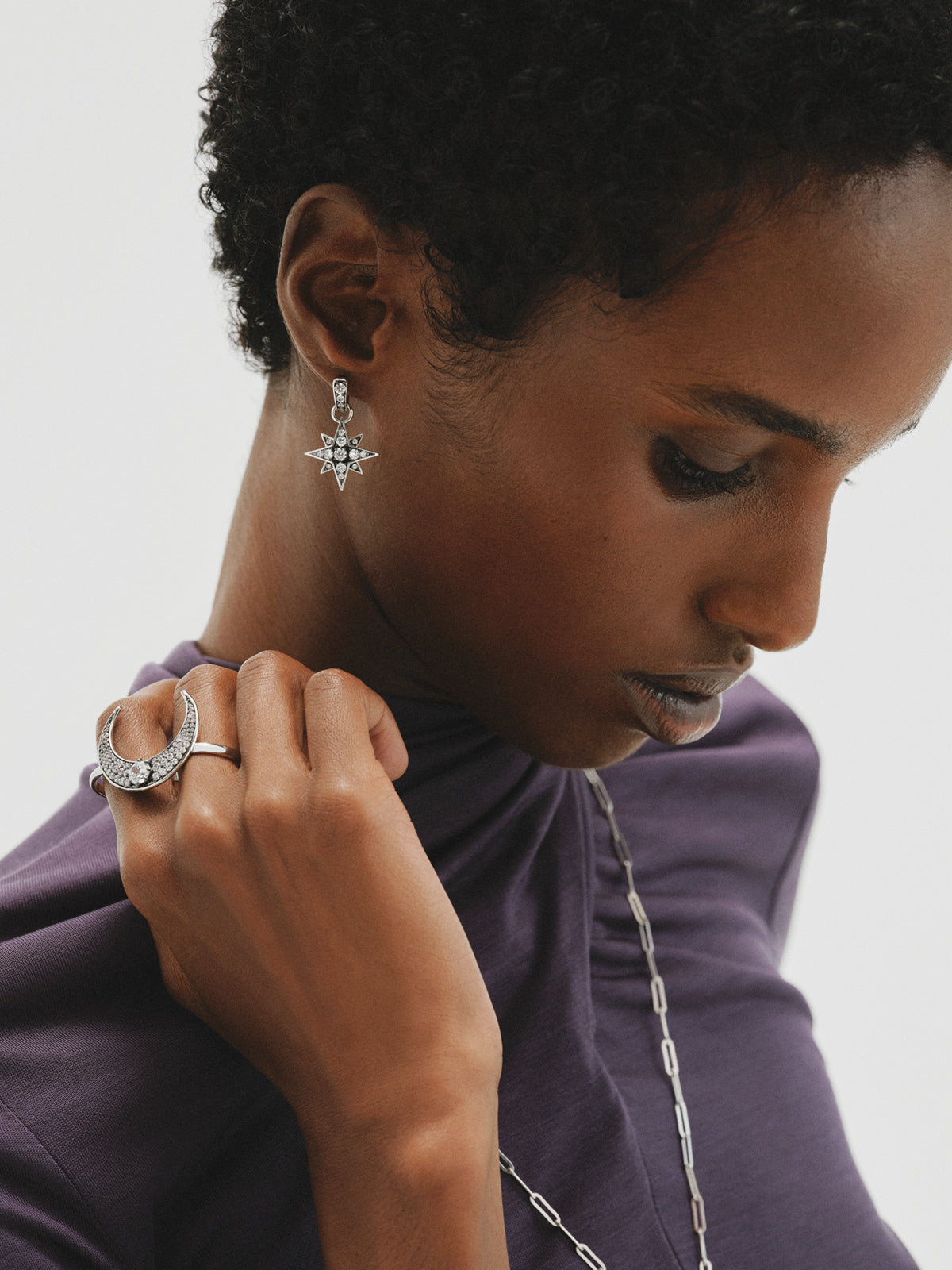 Two-tone hoop earrings with a large star-shaped crystal