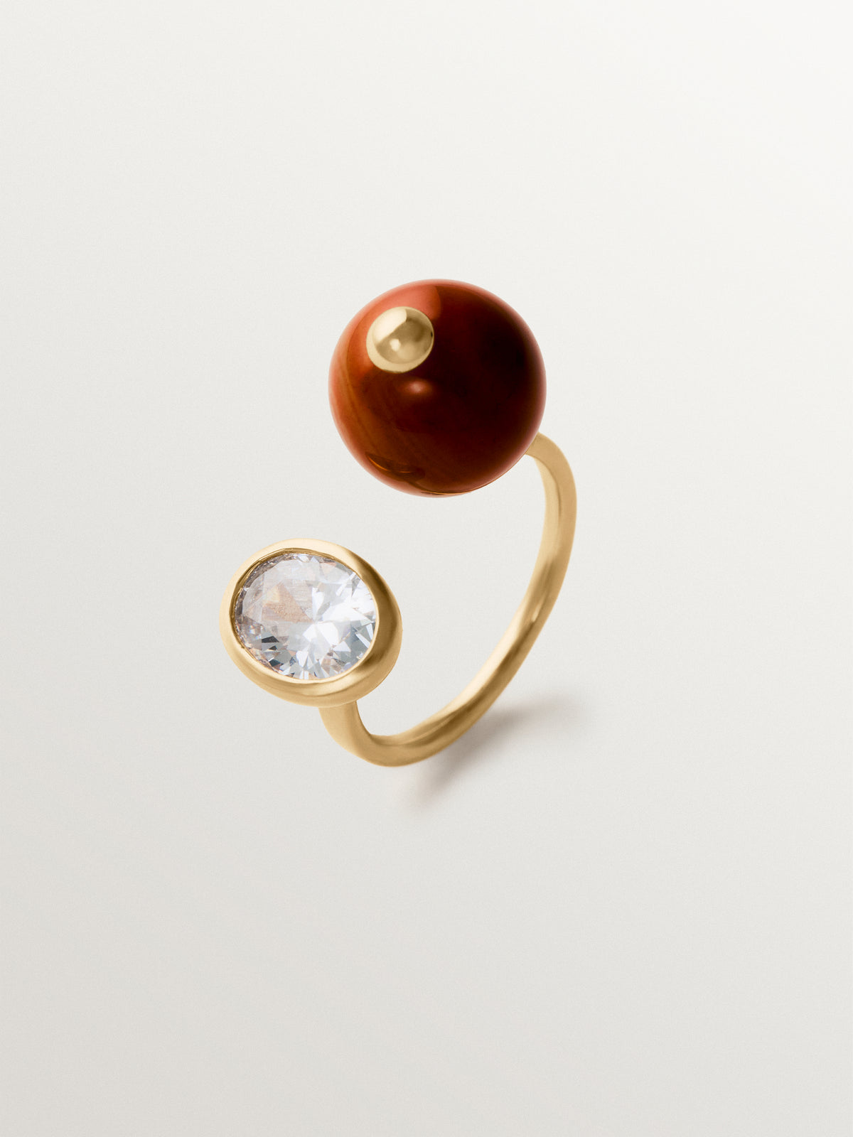Open ring with brushed 18K yellow gold plating, red agate, topaz and sphere motif