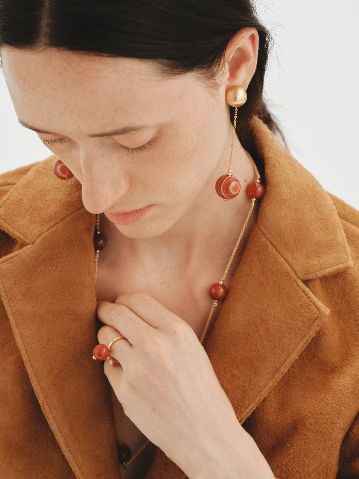 Long earrings with brushed 18K yellow gold plating, red agate and sphere motif