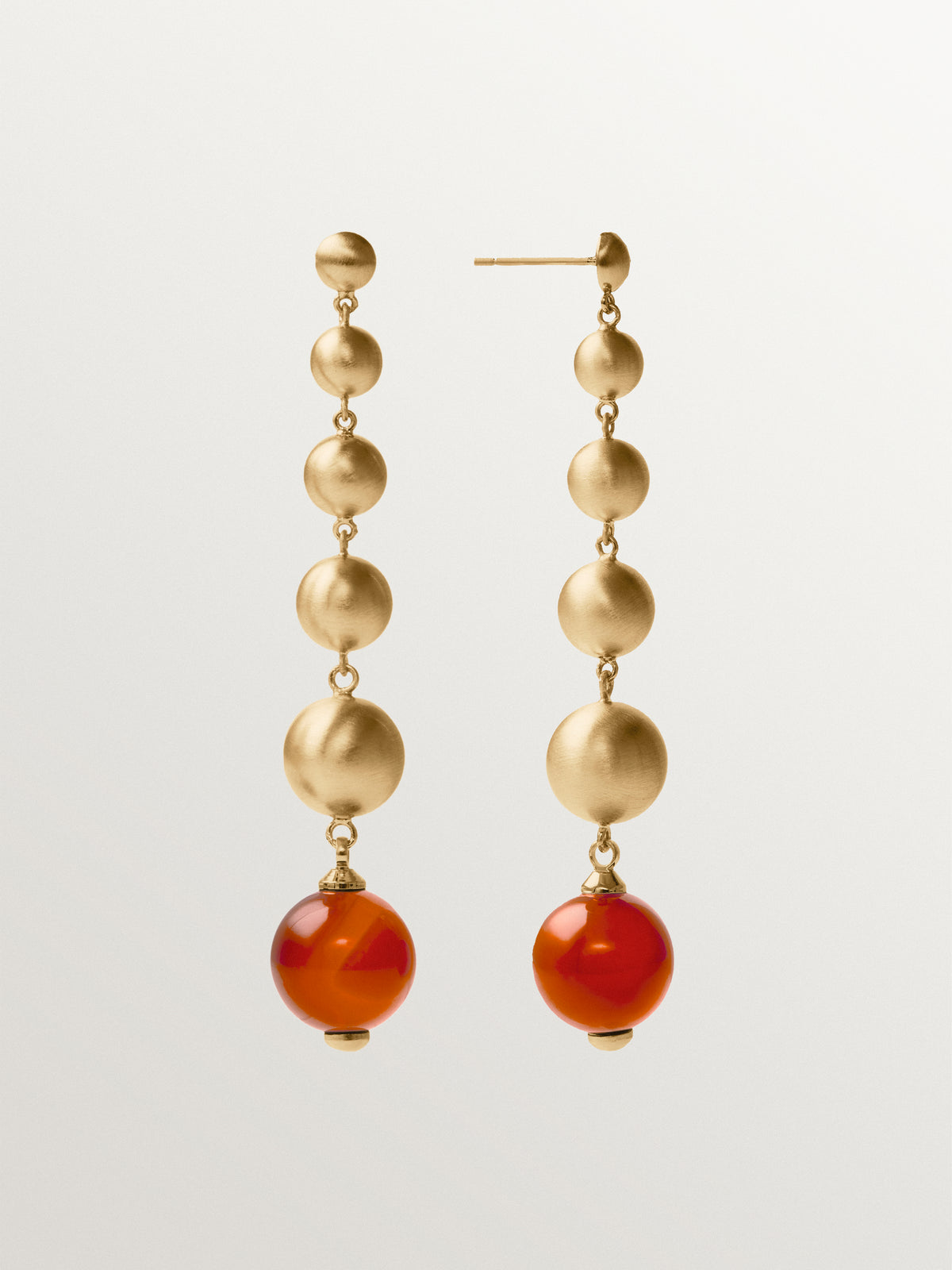 Brushed yellow gold-plated long earrings with red agate and sphere motifs