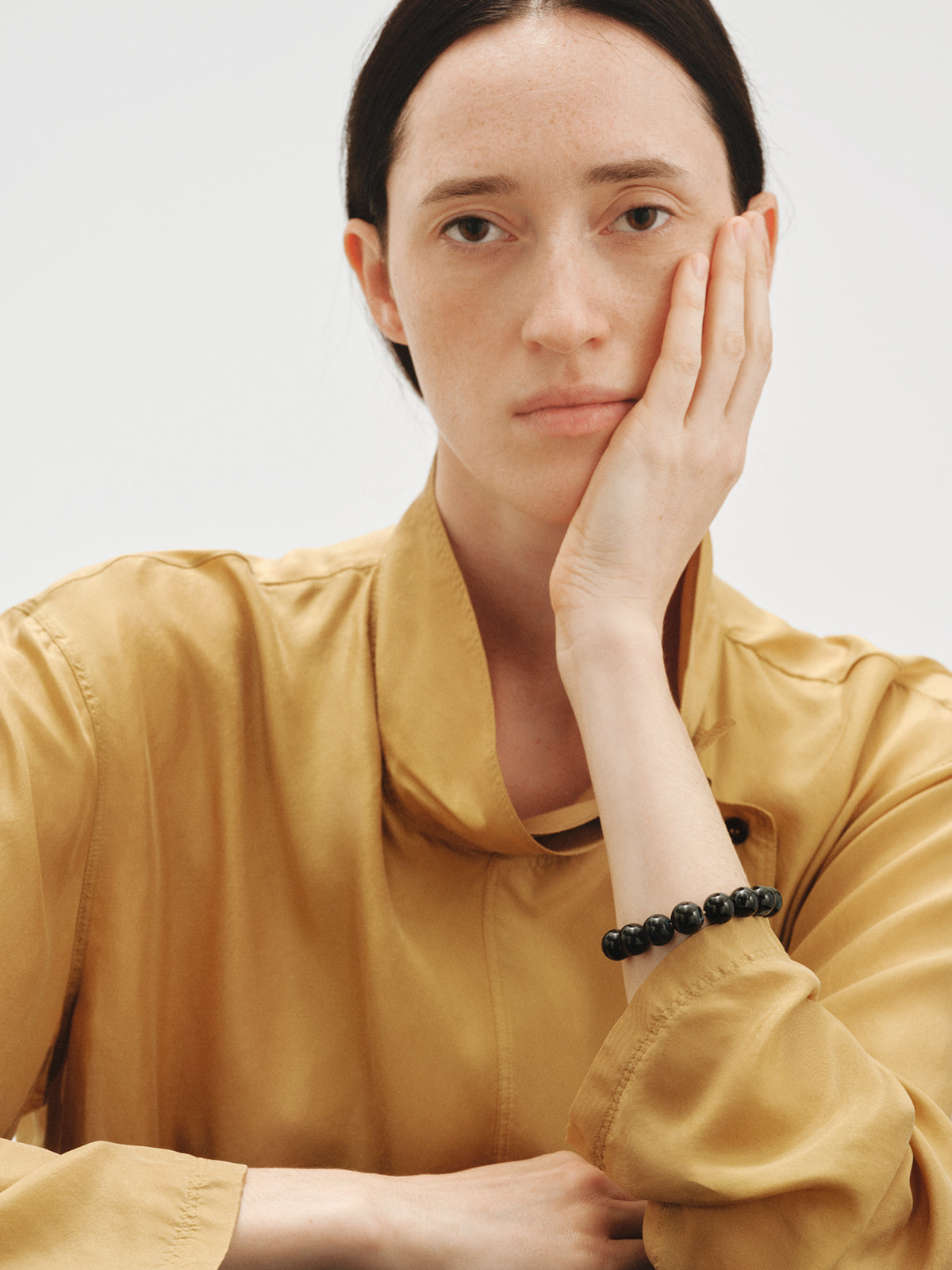Yellow gold-plated bracelet with black agate and sphere motif