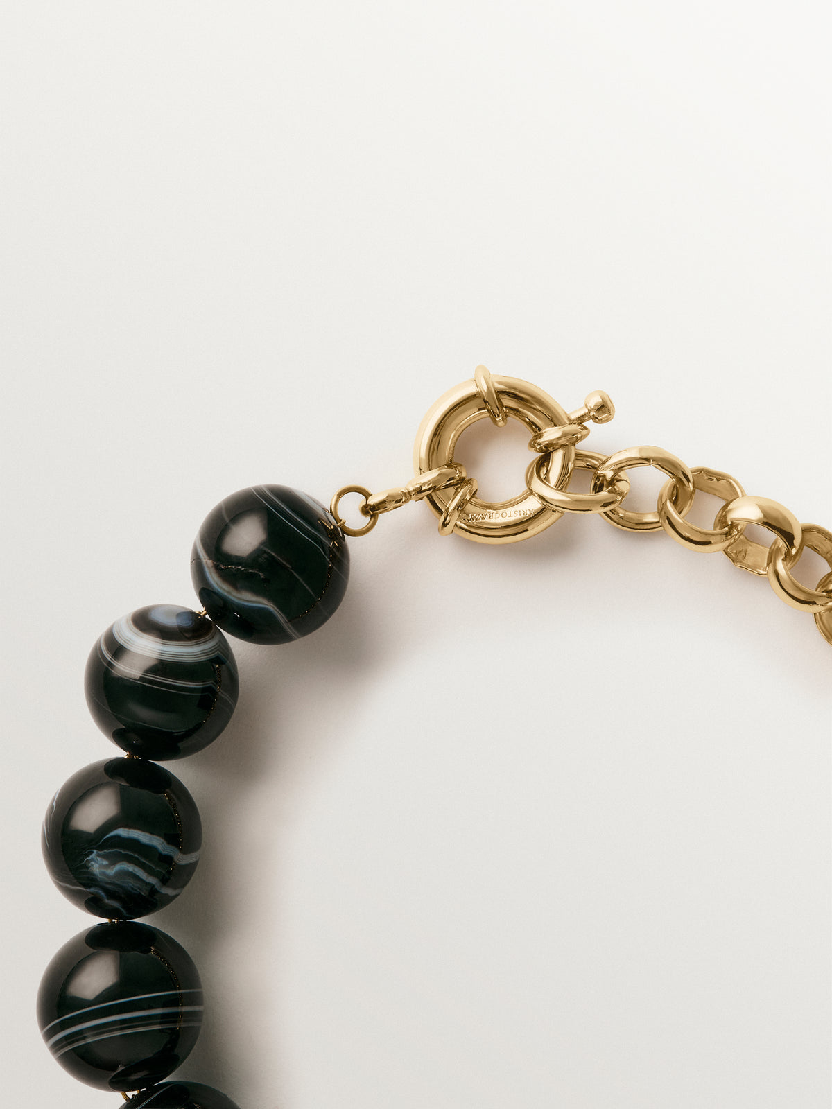 Yellow gold-plated bracelet with black agate and sphere motif