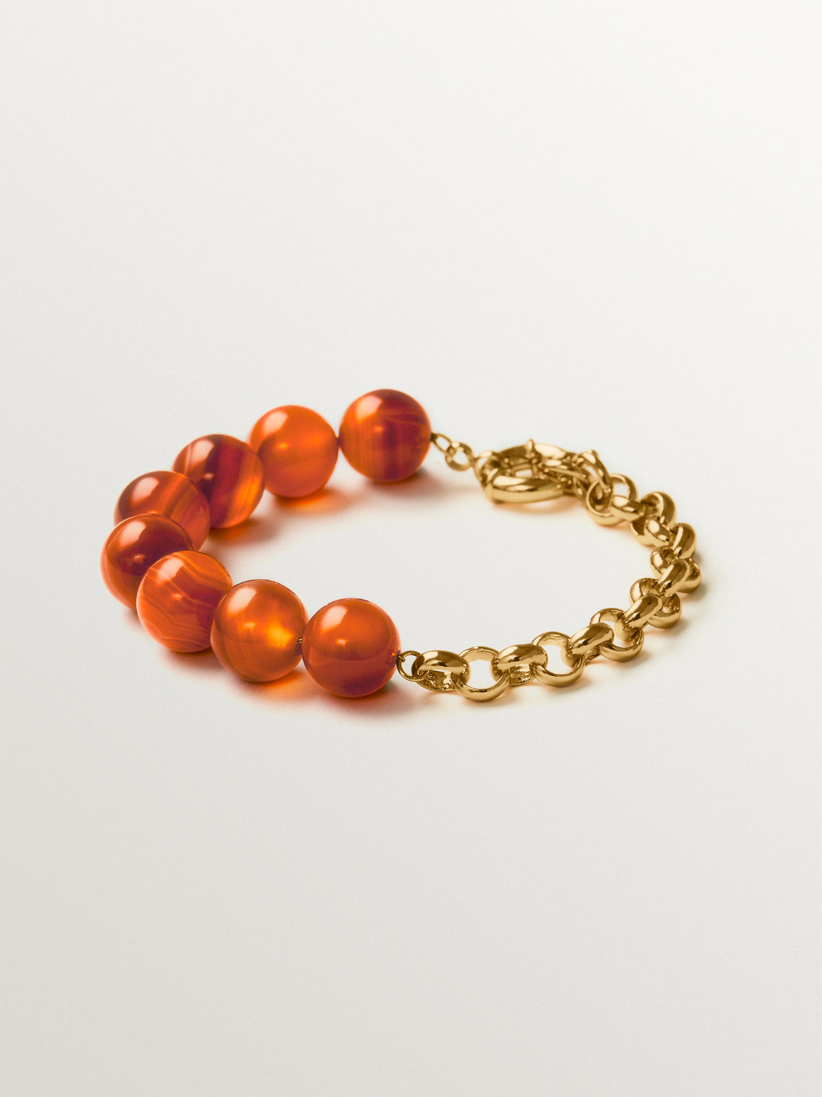 Yellow gold-plated bracelet with red agate and sphere motif