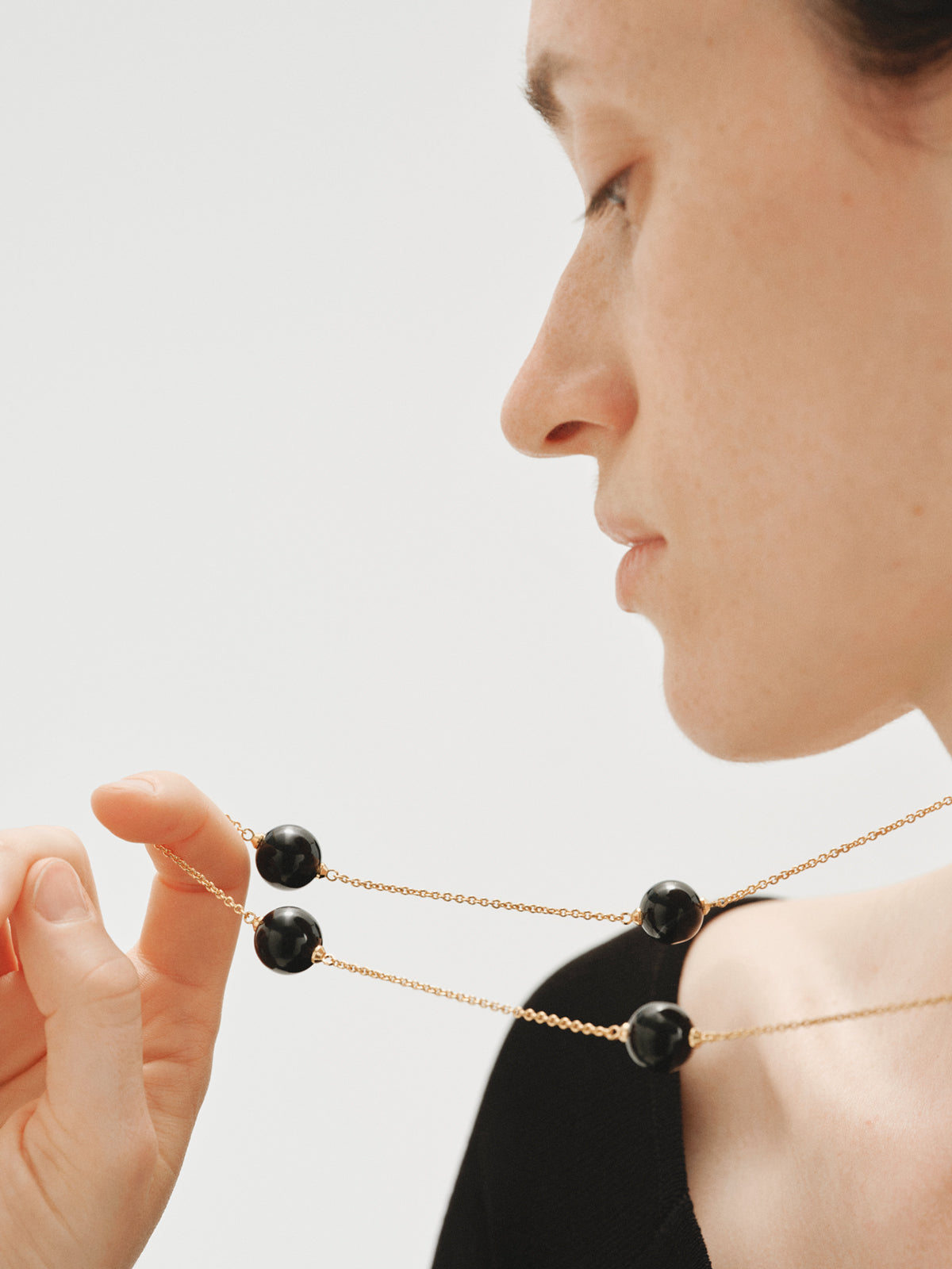 Yellow gold-plated necklace with black agate and sphere motif