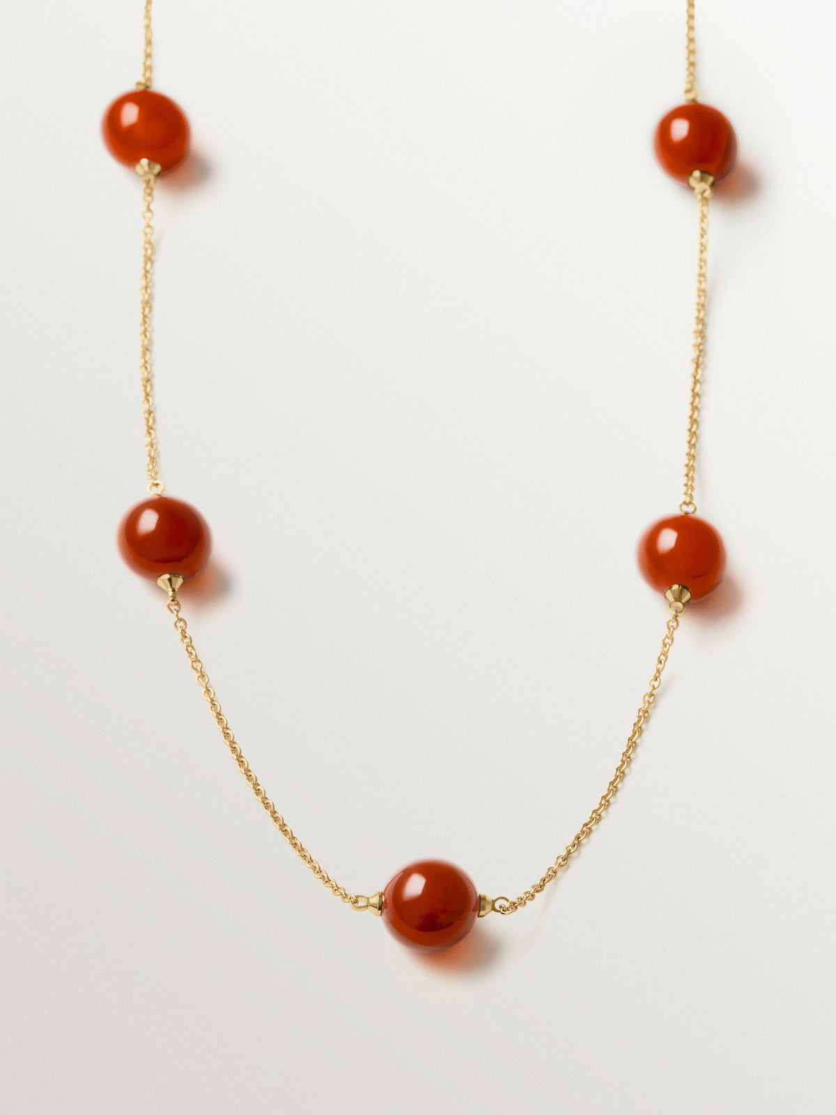 Necklace with brushed 18K yellow gold plating, red agate and sphere motif