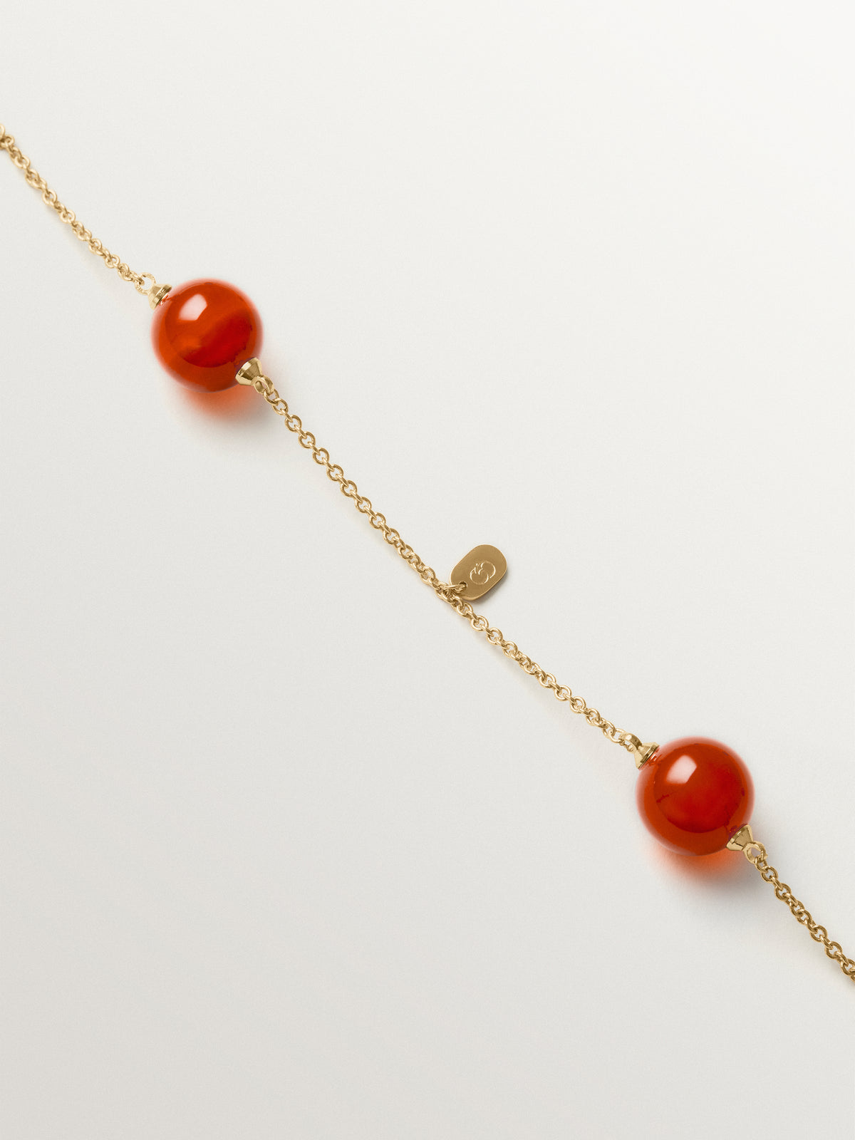 Necklace with brushed 18K yellow gold plating, red agate and sphere motif