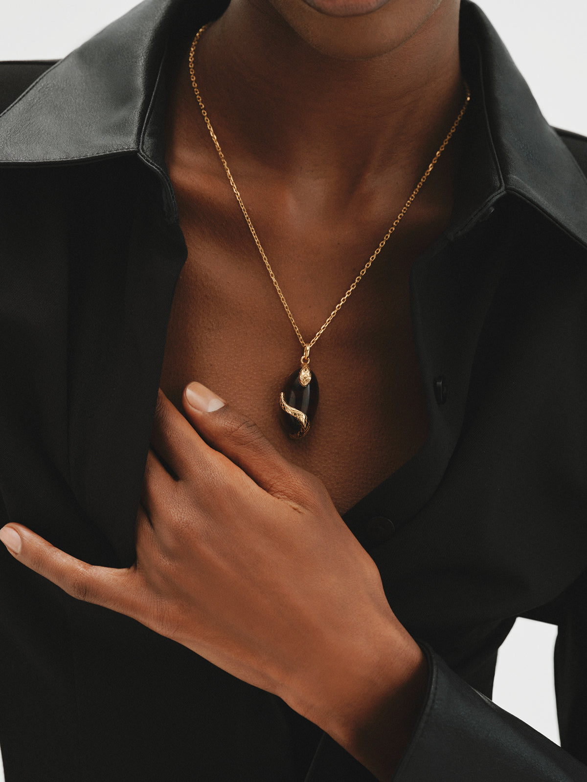 Yellow gold-plated charm with brown crystal and snake motif