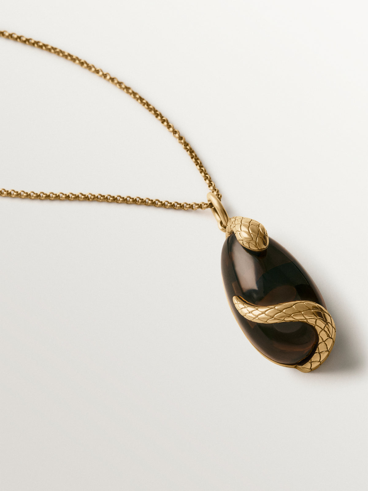 Yellow gold-plated charm with brown crystal and snake motif