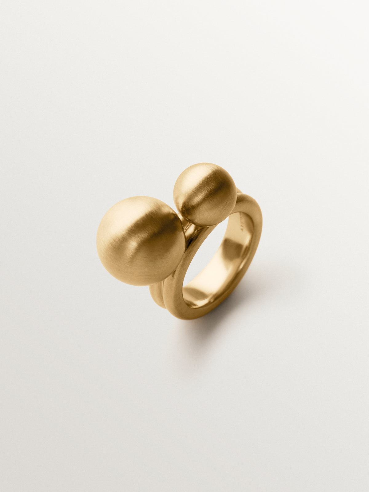 Ring with brushed 18K yellow gold plating and two-sphere motif