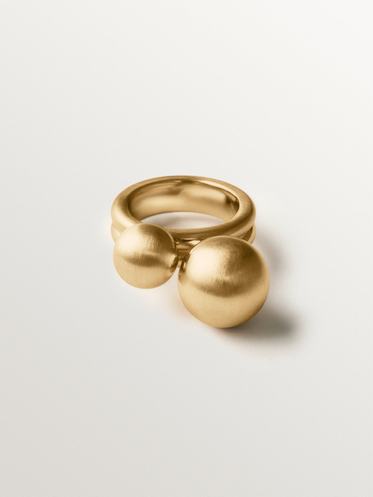 Ring with brushed 18K yellow gold plating and two-sphere motif