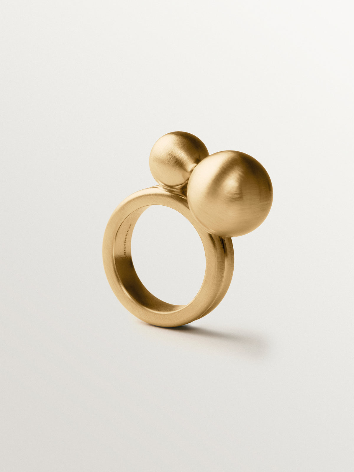 Ring with brushed 18K yellow gold plating and two-sphere motif