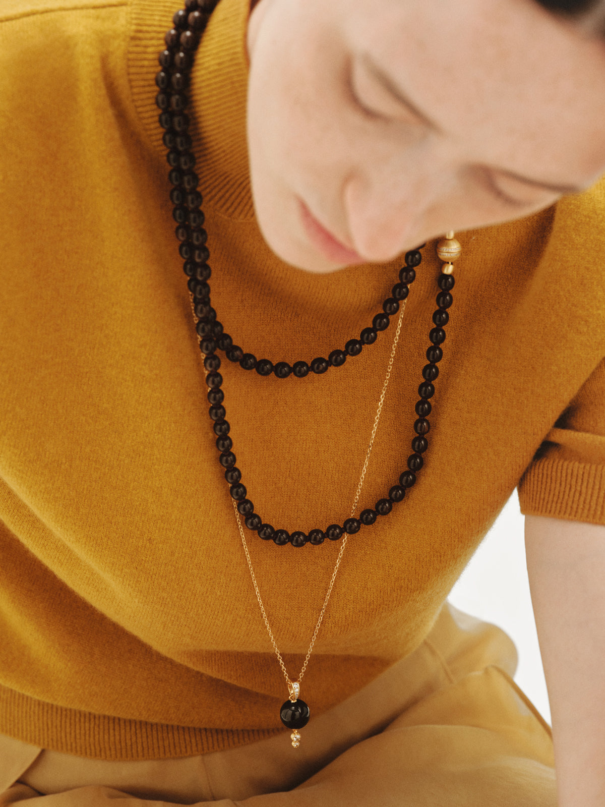 18K yellow gold-plated charm with brown resin, crystals and sphere motif