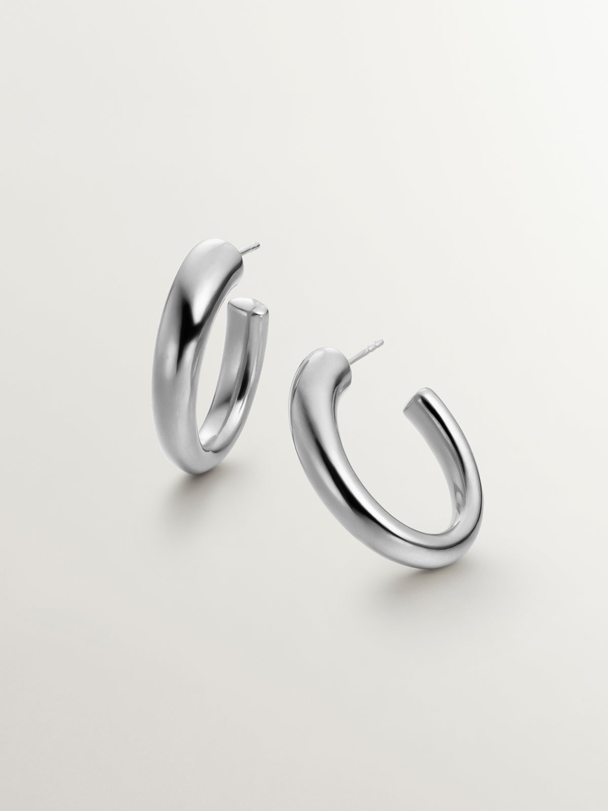 Large and thick 925 silver hoop earrings with an oval shape