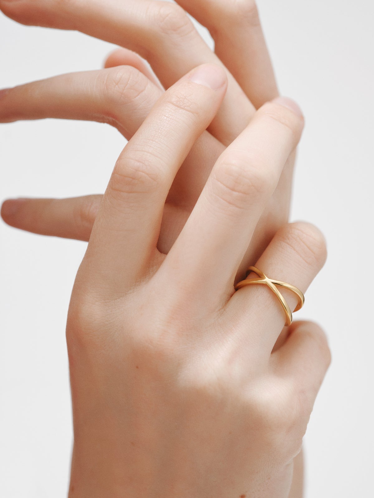 Double Crossed Ring made of 925 Silver coated in 18K Yellow Gold.