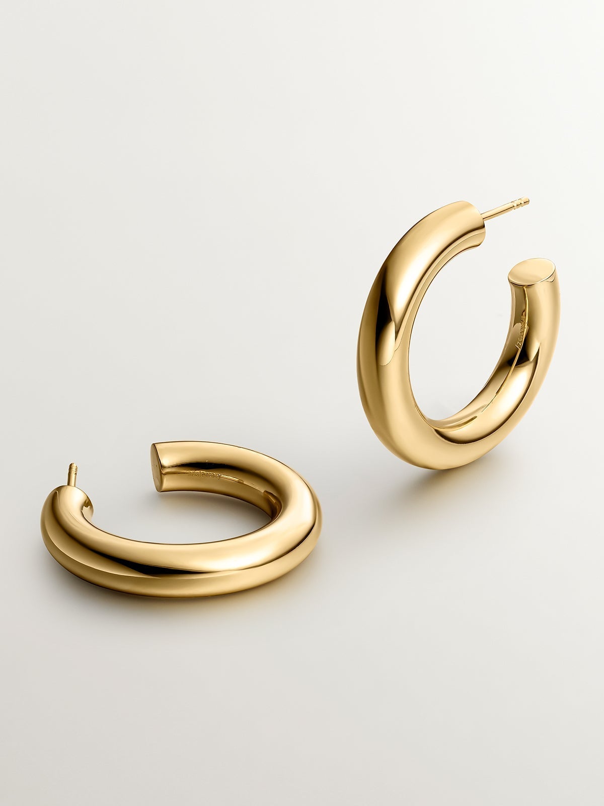 Thick hoop earrings made of 925 silver plated in 18K yellow gold