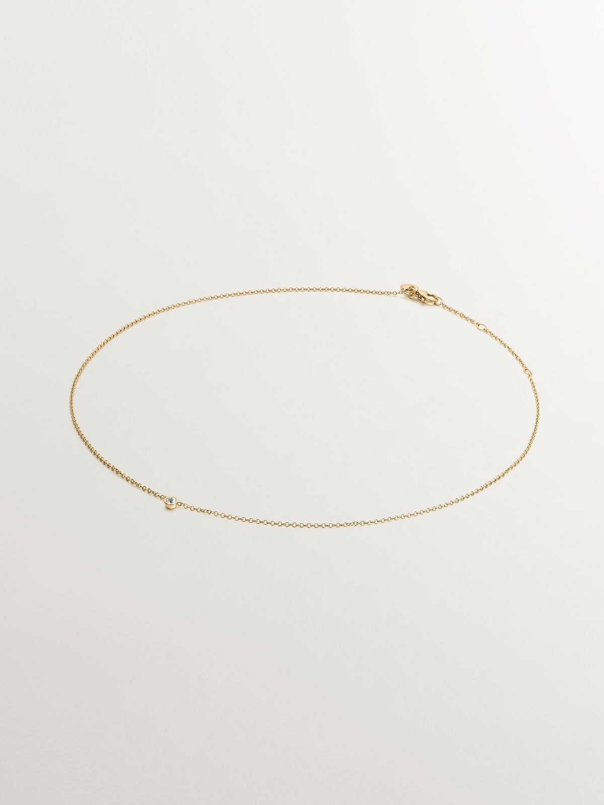 Single 925 silver pendant bathed in 18K yellow gold with white topaz
