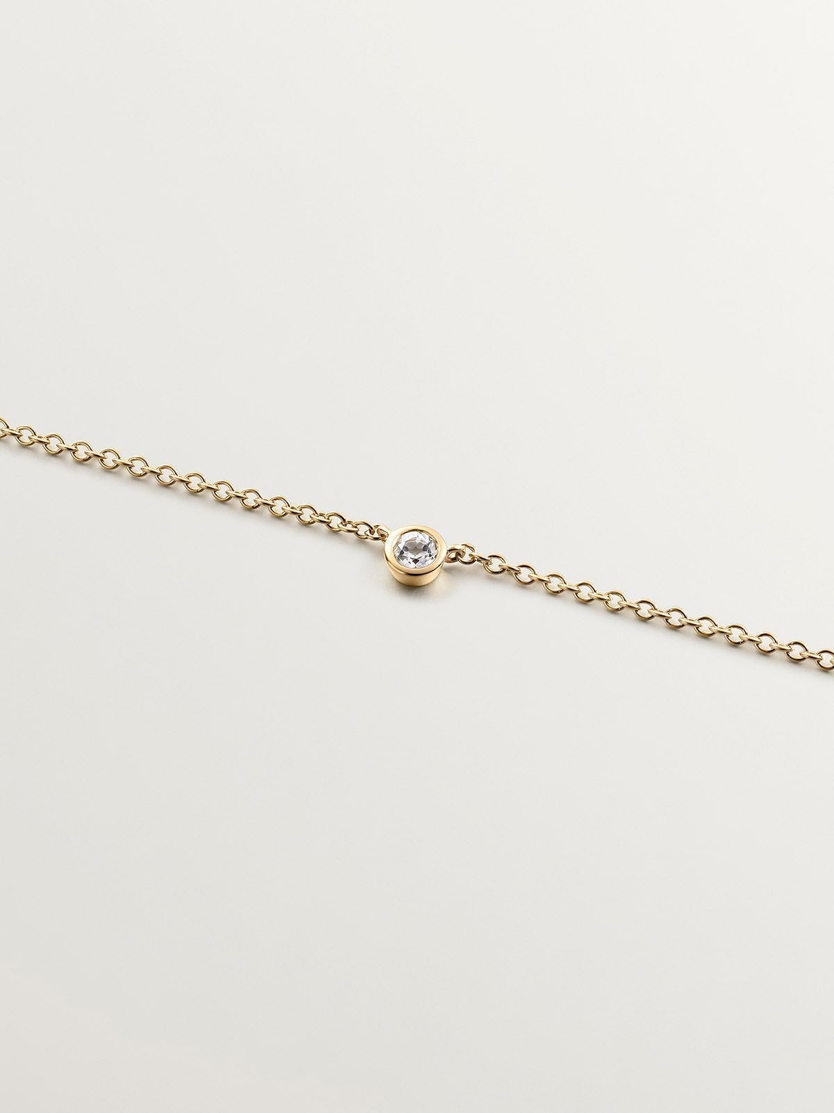 Single 925 silver pendant bathed in 18K yellow gold with white topaz