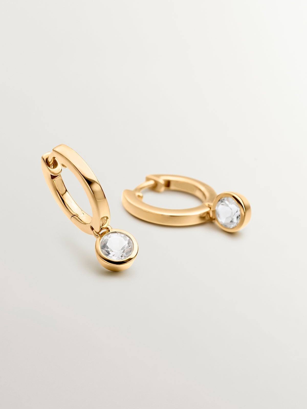Small hoop earrings made from 925 silver, plated in 18K yellow gold with white topaz