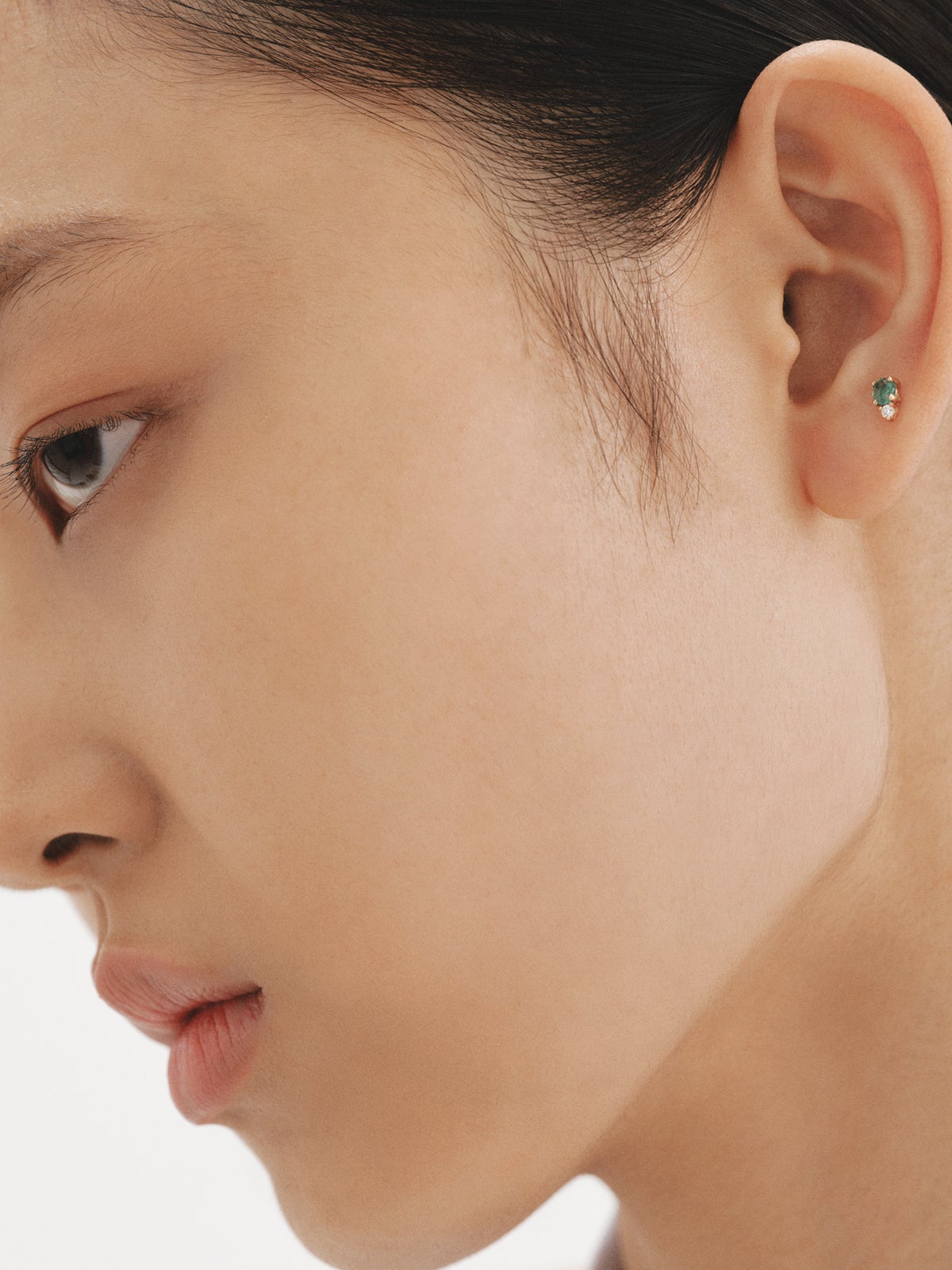 Individual 9K yellow gold earring with emerald and diamond.