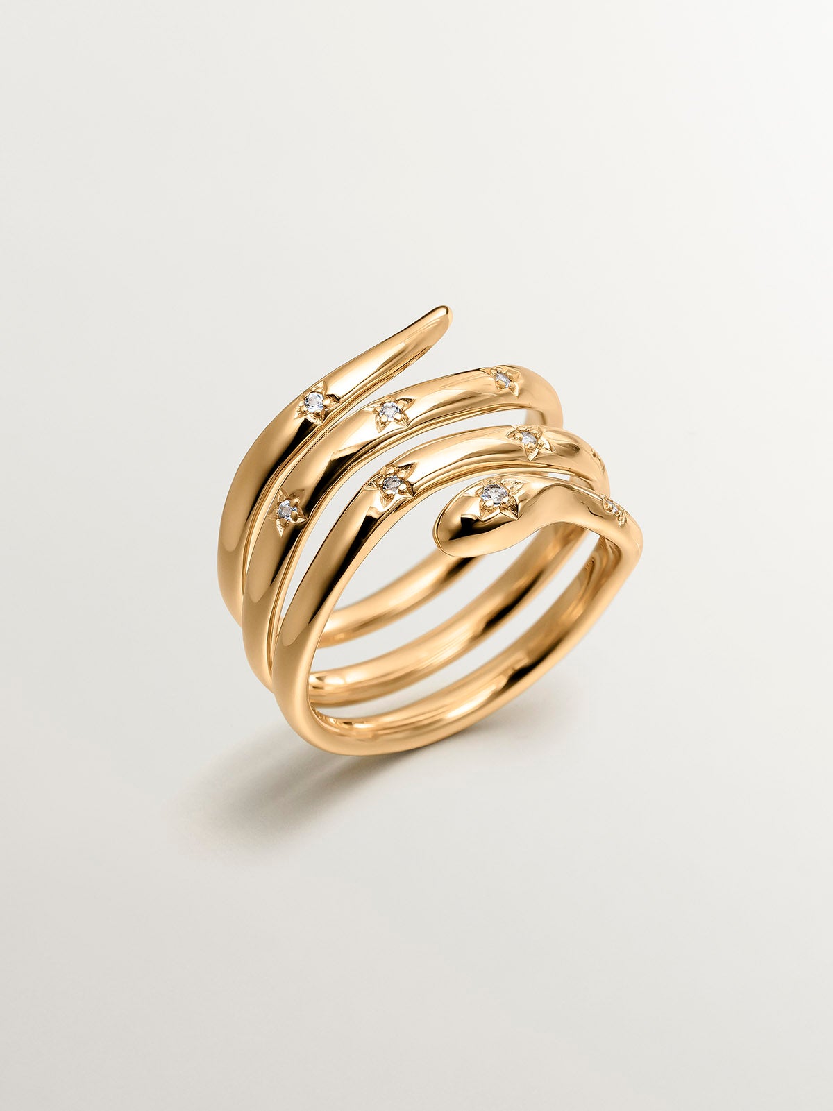 Triple ring in 925 silver plated in 18K yellow gold in the shape of a snake and white topaz
