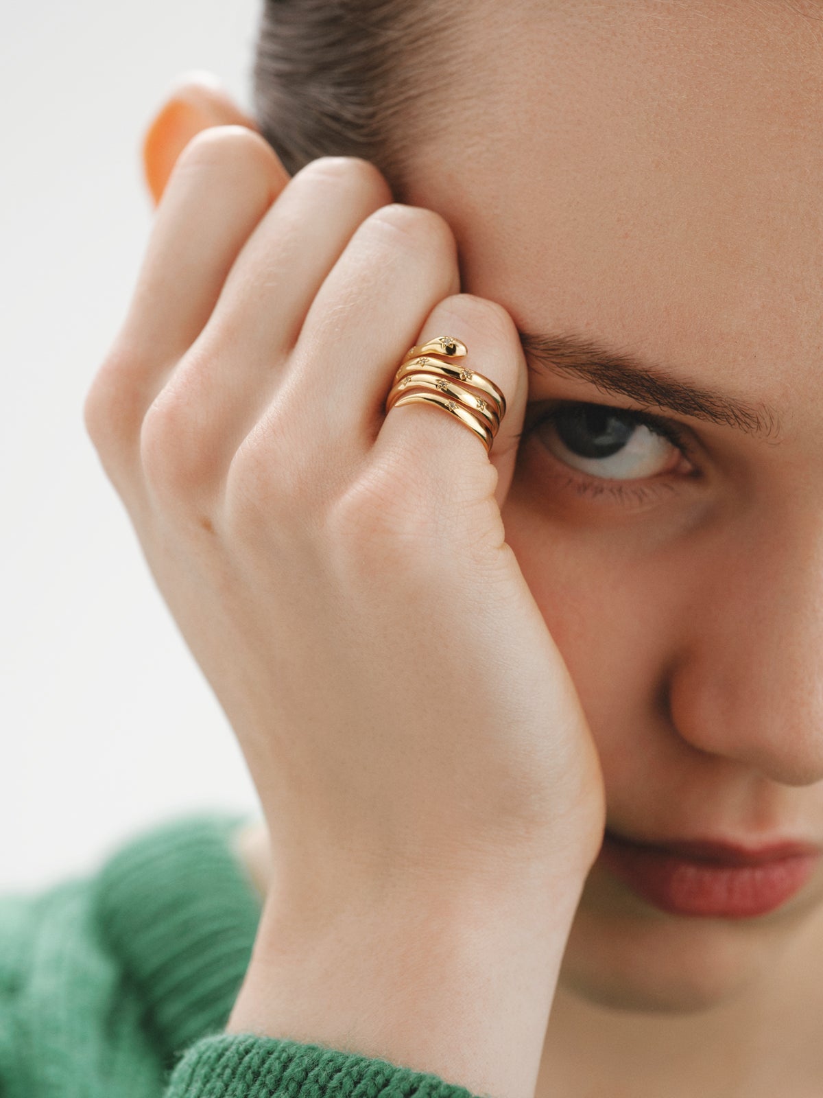 925 Silver triple ring bathed in 18K yellow gold with a snake shape and white topazes.