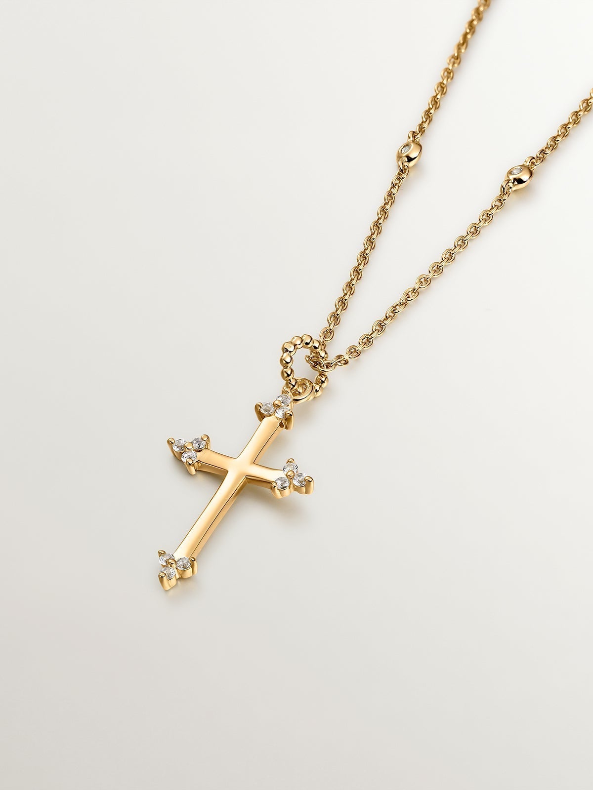 925 Silver pendant dipped in 18K yellow gold featuring a cross and white topazes.