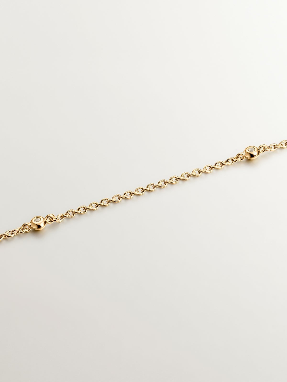 925 Silver pendant dipped in 18K yellow gold featuring a cross and white topazes.