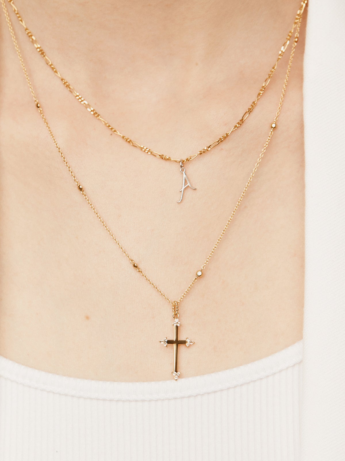 925 Silver pendant dipped in 18K yellow gold featuring a cross and white topazes.