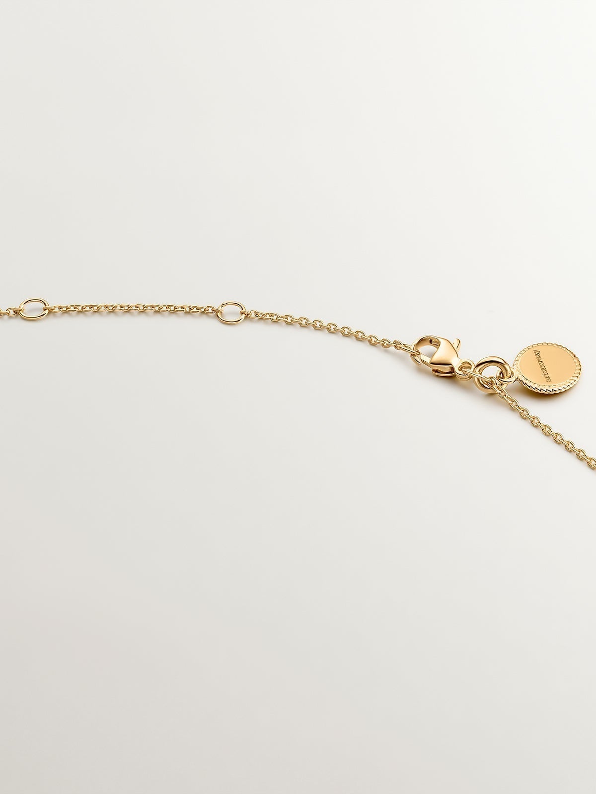 925 Silver pendant dipped in 18K yellow gold featuring a cross and white topazes.